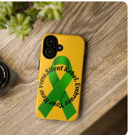 A yellow phone case features a green awareness ribbon surrounded by the words “Silent Rebel. Embrace Your New View.” The case rests on a wooden surface beside a camera lens and a green plant. The design blends advocacy with optimism, suggesting a shift in perspective and a quiet strength in standing up for mental health or related causes.