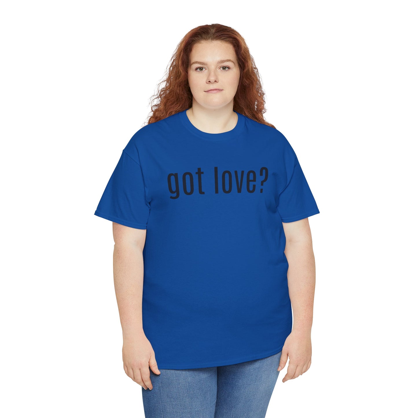 A person stands wearing a royal blue t-shirt with the phrase “got love?” printed in black across the chest. The design plays on familiar advertising language to pose a reflective, heart-centered question. Paired with casual blue jeans and long, curly hair, the look blends simplicity with emotional resonance—inviting connection, compassion, and quiet advocacy.