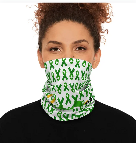 A person wears a white neck gaiter that covers the lower half of the face, featuring a repeating pattern of green awareness ribbons. Paired with a black top and a plain background, the design stands out as a bold yet subtle statement of advocacy. The gaiter blends function with purpose, offering protection, style, and support for causes tied to the green ribbon.