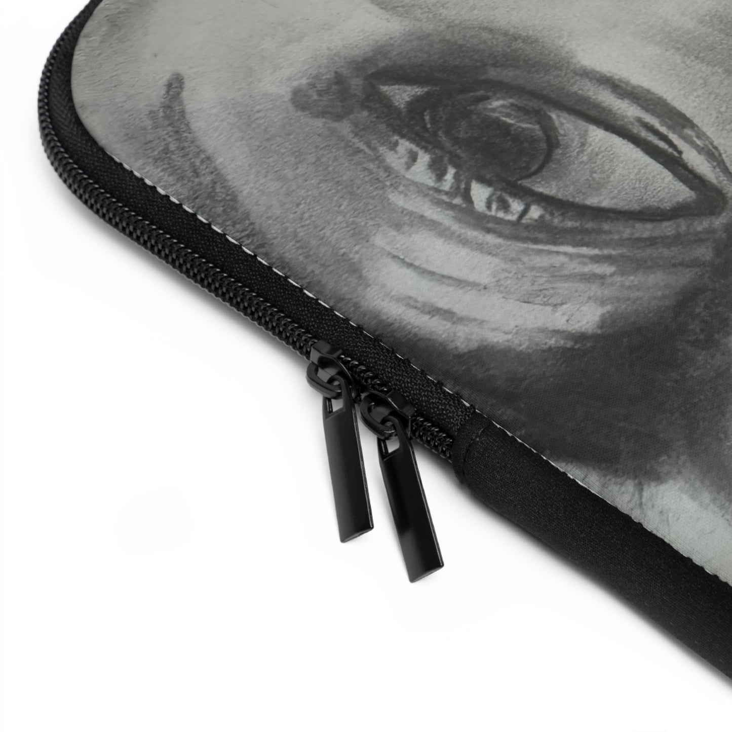 A laptop sleeve features a grayscale, upside-down artistic portrait of a man's face, emphasizing expressive eyes, a defined nose, lips, and a prominent mustache. A small green awareness ribbon appears in the bottom right corner, symbolizing support for causes like mental health. The sleeve includes a zipper on the left side, combining secure functionality with bold, personal expression and advocacy.
